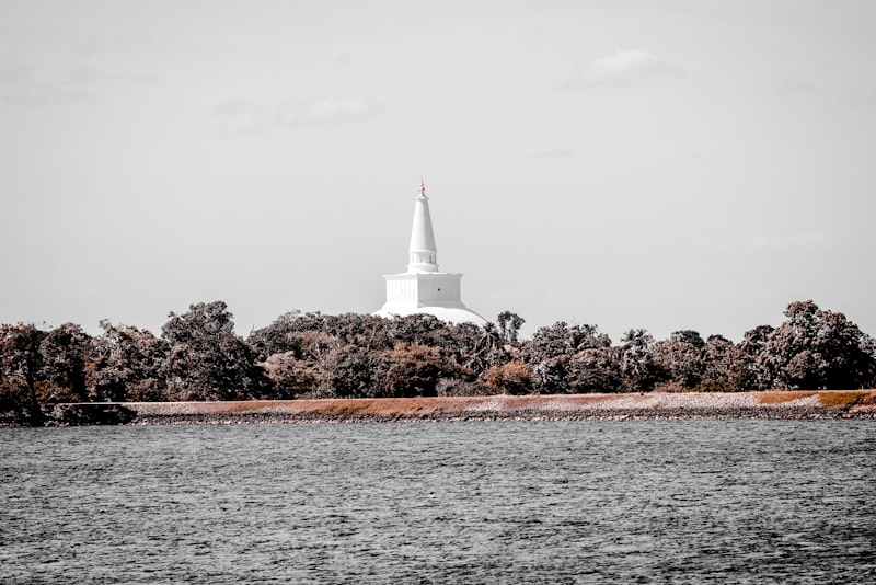 Sri Maha Bodhi, the sacred Bo Tree in Anuradhapura, surrounded by gold railings and prayer flags