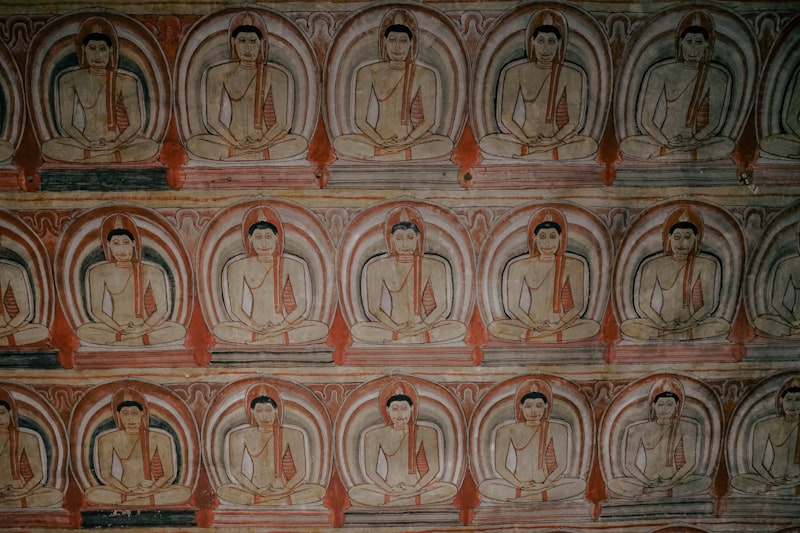 Rows of seated Buddha statues inside Cave 2 of Dambulla, the largest and most impressive cave