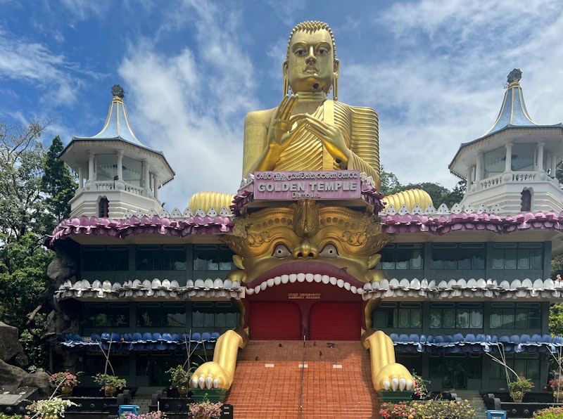 The large golden Buddha statue atop the modern Golden Temple at the base of Dambulla