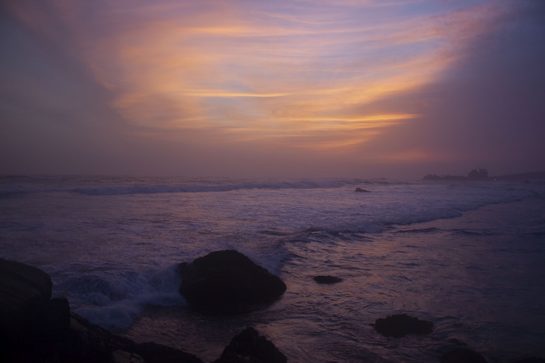 Surfer catching a wave at Mirissa Beach
